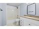 Cozy bathroom with a shower and tub combination, large mirror and a granite countertop at 740 Marcus Nyah Ct, Atlanta, GA 30349