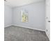 Bedroom featuring gray carpet, a window with blinds, and a white door at 740 Marcus Nyah Ct, Atlanta, GA 30349