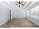 Bedroom with wood floors, tray ceilings, and a ceiling fan at 740 Marcus Nyah Ct, Atlanta, GA 30349