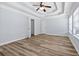 Bright bedroom features a ceiling fan, wood floors, tray ceilings, and plentiful natural light at 740 Marcus Nyah Ct, Atlanta, GA 30349