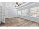 Bedroom features wood floors, a tray ceiling, and many windows at 740 Marcus Nyah Ct, Atlanta, GA 30349