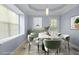 Dining room featuring a table, six chairs, a window and a tray ceiling at 740 Marcus Nyah Ct, Atlanta, GA 30349