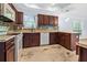 This is a kitchen featuring dark wood cabinets, granite countertops, and stainless steel appliances at 740 Marcus Nyah Ct, Atlanta, GA 30349