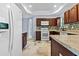 This is a kitchen featuring dark wood cabinets, granite countertops, and stainless steel appliances at 740 Marcus Nyah Ct, Atlanta, GA 30349