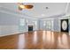 Well-lit living room features a fireplace and entry way with a hardwood floor and ceiling fan at 740 Marcus Nyah Ct, Atlanta, GA 30349