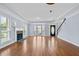 Bright living room with hardwood floors, fireplace, and staircase to the second floor at 740 Marcus Nyah Ct, Atlanta, GA 30349