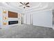 This is a bedroom with gray carpeting, a modern fireplace feature, and large windows at 740 Marcus Nyah Ct, Atlanta, GA 30349