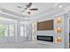 This is a large main bedroom with a modern fireplace feature, tray ceiling, and multiple windows at 740 Marcus Nyah Ct, Atlanta, GA 30349