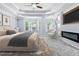 A staged main bedroom features a king bed, modern fireplace, large windows, and sitting area at 740 Marcus Nyah Ct, Atlanta, GA 30349