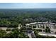 Aerial view of community with lush green trees, parking and storefronts at 10090 Jones Bridge Rd # 2, Alpharetta, GA 30022