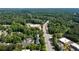 Aerial view of the property with parking, roads, and retail at 10090 Jones Bridge Rd # 2, Alpharetta, GA 30022