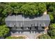 Aerial view of townhomes with dark roofs and surrounding trees at 10090 Jones Bridge Rd # 2, Alpharetta, GA 30022