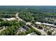 Overhead view of the property near businesses, roads, parking, and lush trees at 10090 Jones Bridge Rd # 2, Alpharetta, GA 30022