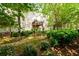 Home with lush green backyard and multiple outdoor seating areas at 10090 Jones Bridge Rd # 2, Alpharetta, GA 30022