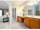 Elegant bathroom featuring double vanities, tile flooring, and a separate water closet at 10090 Jones Bridge Rd # 2, Alpharetta, GA 30022