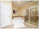 Gorgeous bathroom featuring a soaking tub, a glass-enclosed shower, and neutral tones at 10090 Jones Bridge Rd # 2, Alpharetta, GA 30022