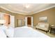 Lovely bedroom with tray ceilings, natural light and access to en suite bathroom and walk-in closets at 10090 Jones Bridge Rd # 2, Alpharetta, GA 30022
