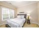 Cozy bedroom featuring a twin bed, natural light, and neutral tones at 10090 Jones Bridge Rd # 2, Alpharetta, GA 30022