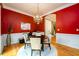 This dining area boasts red walls, wainscoting, and decorative lighting at 10090 Jones Bridge Rd # 2, Alpharetta, GA 30022