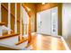Warm and inviting foyer with hardwood floors, a staircase, and a front door with sidelights at 10090 Jones Bridge Rd # 2, Alpharetta, GA 30022