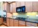 Modern kitchen with granite countertops and light wood cabinetry at 10090 Jones Bridge Rd # 2, Alpharetta, GA 30022