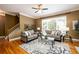 Comfortable living room featuring hardwood floors, large windows, and a ceiling fan at 10090 Jones Bridge Rd # 2, Alpharetta, GA 30022