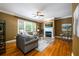 Comfortable living room featuring a fireplace, hardwood floors, and large windows at 10090 Jones Bridge Rd # 2, Alpharetta, GA 30022