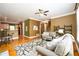 Open-concept living room with hardwood floors, a view of the kitchen, and comfortable seating at 10090 Jones Bridge Rd # 2, Alpharetta, GA 30022