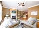 Cozy living room with hardwood floors, a fireplace, and an open view into the kitchen at 10090 Jones Bridge Rd # 2, Alpharetta, GA 30022