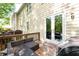 Outdoor patio with wicker seating and French door access to interior at 10090 Jones Bridge Rd # 2, Alpharetta, GA 30022