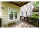 Covered patio with French door access and wooden railing at 10090 Jones Bridge Rd # 2, Alpharetta, GA 30022