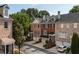 Charming townhomes with brick facades, black shutters, and attached garages at 10090 Jones Bridge Rd # 2, Alpharetta, GA 30022