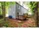 Back of home with deck overlooking wooded yard at 3001 Majestic Park Ct, Duluth, GA 30096