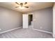 Well lit bedroom offering a ceiling fan and neutral carpet at 3001 Majestic Park Ct, Duluth, GA 30096