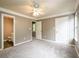Spacious bedroom with neutral carpet, gray walls, ceiling fan, and ensuite bathroom at 3001 Majestic Park Ct, Duluth, GA 30096