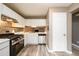 Renovated kitchen boasts stainless steel appliances, white cabinets, and stylish backsplash at 3001 Majestic Park Ct, Duluth, GA 30096