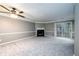 Open living space with a fireplace, plush carpet, and sliding glass doors at 3001 Majestic Park Ct, Duluth, GA 30096