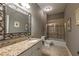 This bathroom features a granite countertop vanity and tile-surround shower with glass doors at 3680 Milton Park Dr, Alpharetta, GA 30022
