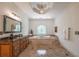 Spacious bathroom featuring a soaking tub under a decorative window and chandelier at 3680 Milton Park Dr, Alpharetta, GA 30022