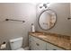 Bathroom featuring a round mirror, vanity, and toilet at 3680 Milton Park Dr, Alpharetta, GA 30022