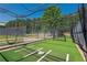 Community baseball batting cage on green turf with net and equipment at 3680 Milton Park Dr, Alpharetta, GA 30022