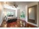 Bedroom featuring hardwood floors, a large window, and a decorative mirror at 3680 Milton Park Dr, Alpharetta, GA 30022