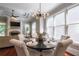 Bright dining room featuring a decorative chandelier, large windows, and wood flooring at 3680 Milton Park Dr, Alpharetta, GA 30022