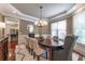 Elegant dining room with decorative crown molding, chandelier, and natural lighting at 3680 Milton Park Dr, Alpharetta, GA 30022