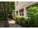 A stone walkway and lush landscaping add charm to this inviting home exterior at 3680 Milton Park Dr, Alpharetta, GA 30022