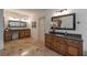 Spacious primary bathroom featuring double vanities, granite countertops, and a tile floor at 3680 Milton Park Dr, Alpharetta, GA 30022