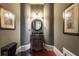 Charming powder room featuring a vanity with antique-style cabinetry and decorative lighting at 3680 Milton Park Dr, Alpharetta, GA 30022