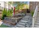 Multi-tiered backyard patio with a dining area, stone steps, and decorative rocks at 44 Barbara Ln, Atlanta, GA 30327