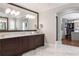 Upscale bathroom boasting a large vanity with double mirrors, and a walk-in closet in view at 44 Barbara Ln, Atlanta, GA 30327