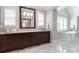 Elegant bathroom featuring dual sinks, a soaking tub, marble floors, and plenty of natural light at 44 Barbara Ln, Atlanta, GA 30327